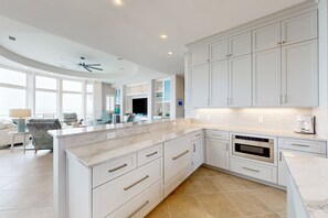 Enjoy cooking in this well-lit kitchen with a large island and appliances.