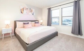 Relax in this serene bedroom with a large bed, nightstand, and stunning view.