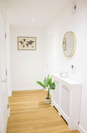 Stunning hallway with a world map, potted plant, and elegant console table.