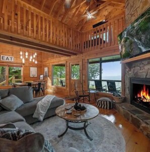 Cozy seating area with a fireplace, sectional sofa, and additional seating options.