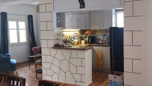 A compact living space with a kitchen area, a dining area, and a visible bathroom. - Holiday home for special people (El-Agamy)