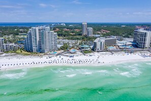 A coastal resort with high-rise hotels, a sandy beach, and a marina.