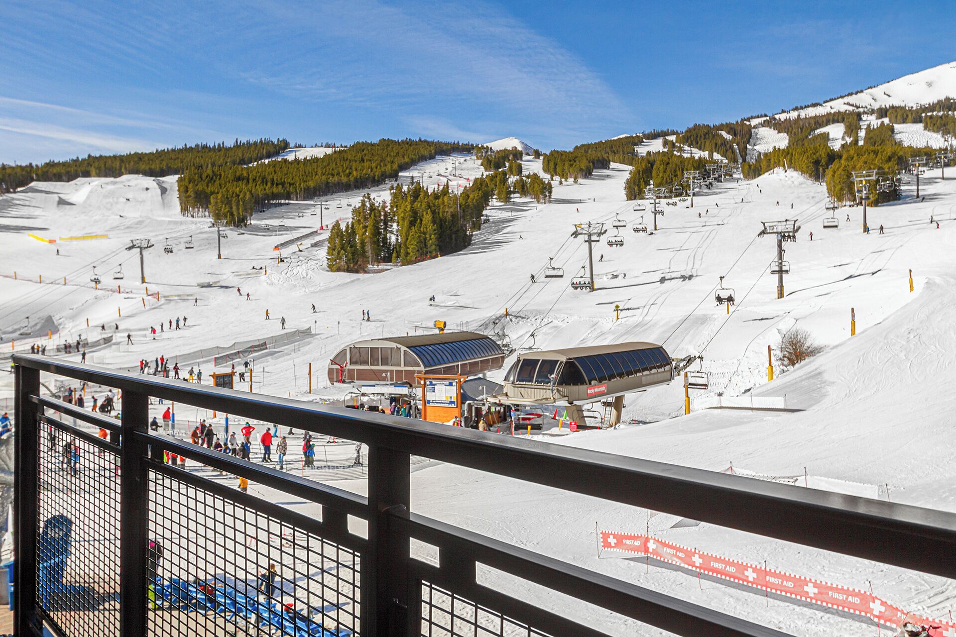 A ski resort with a chairlift, ski slopes, and a first aid station.