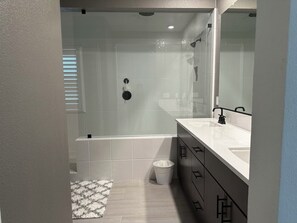Combined shower/bathtub, hair dryer, towels, toilet paper