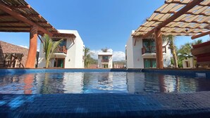 A pool area with two buildings, one labeled "PARKATANA." - Amazing private beachfront Village (Troncones)