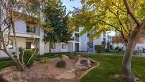 A residential building with a landscaped garden, including rocks and trees. - Las Palmas Resort #1638 | All-Inclusive Amenities (Saint George)
