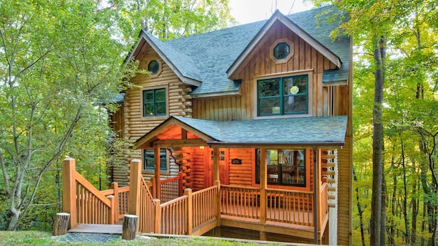 A log cabin with a porch, multiple windows, and a number '670' sign. - Hideaway Homestead - Private 3BR home between Boone/ Banner Elk! Pet friendly, excellent location! (Banner Elk)