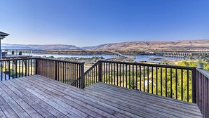 A wooden deck with a view of a river and mountains. - Incredible Oregon Retreat w/ Private Hot Tub! (The Dalles)