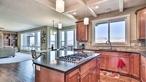 A spacious kitchen with a central island, large windows, and a view of the outdoors. - Incredible Oregon Retreat w/ Private Hot Tub! (The Dalles)