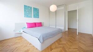 A modern bedroom with a bed, a bedside table, a hanging light, and a wardrobe. - Your comfy stay in Central Sarajevo (Sarajevo)