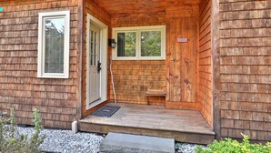A wooden cabin with a porch, a door, and a window. - Charming Glazebrook Condo - 1 Mile to Lifts - Close to everything! J3 (Killington)
