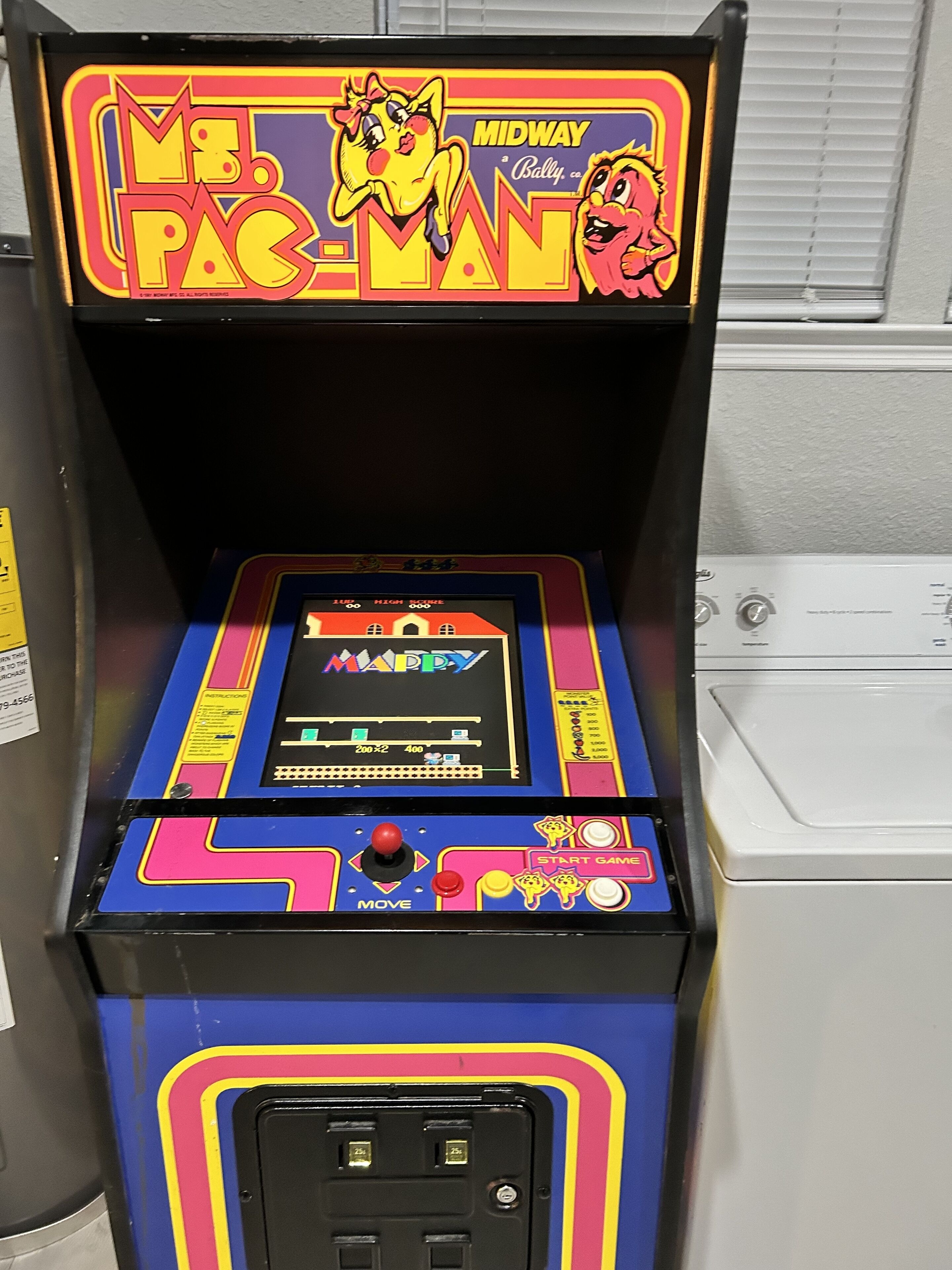 A vintage arcade machine with a colorful display and a joystick.