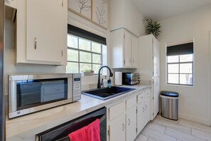 Enjoy cooking in this well-equipped kitchen with an oven, microwave, and sink.