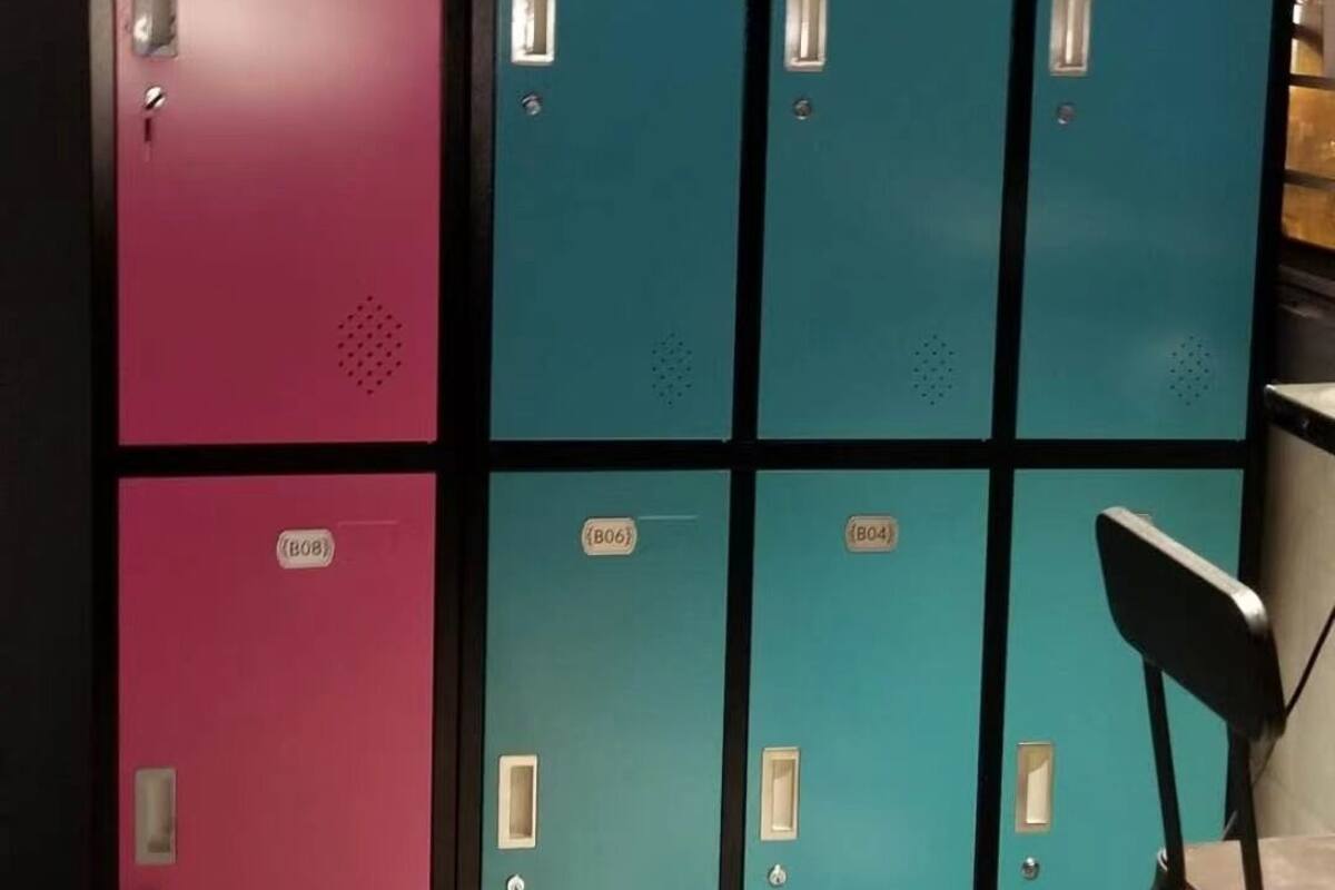 A row of lockers with a chair in front.