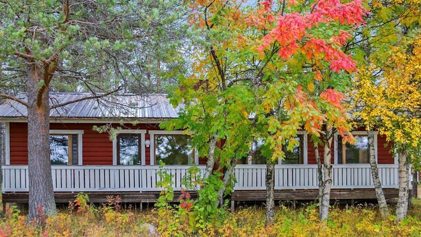 A cabin with a wooden deck and a metal roof. - Pihatupa 2 by Interhome (Kuusamo)
