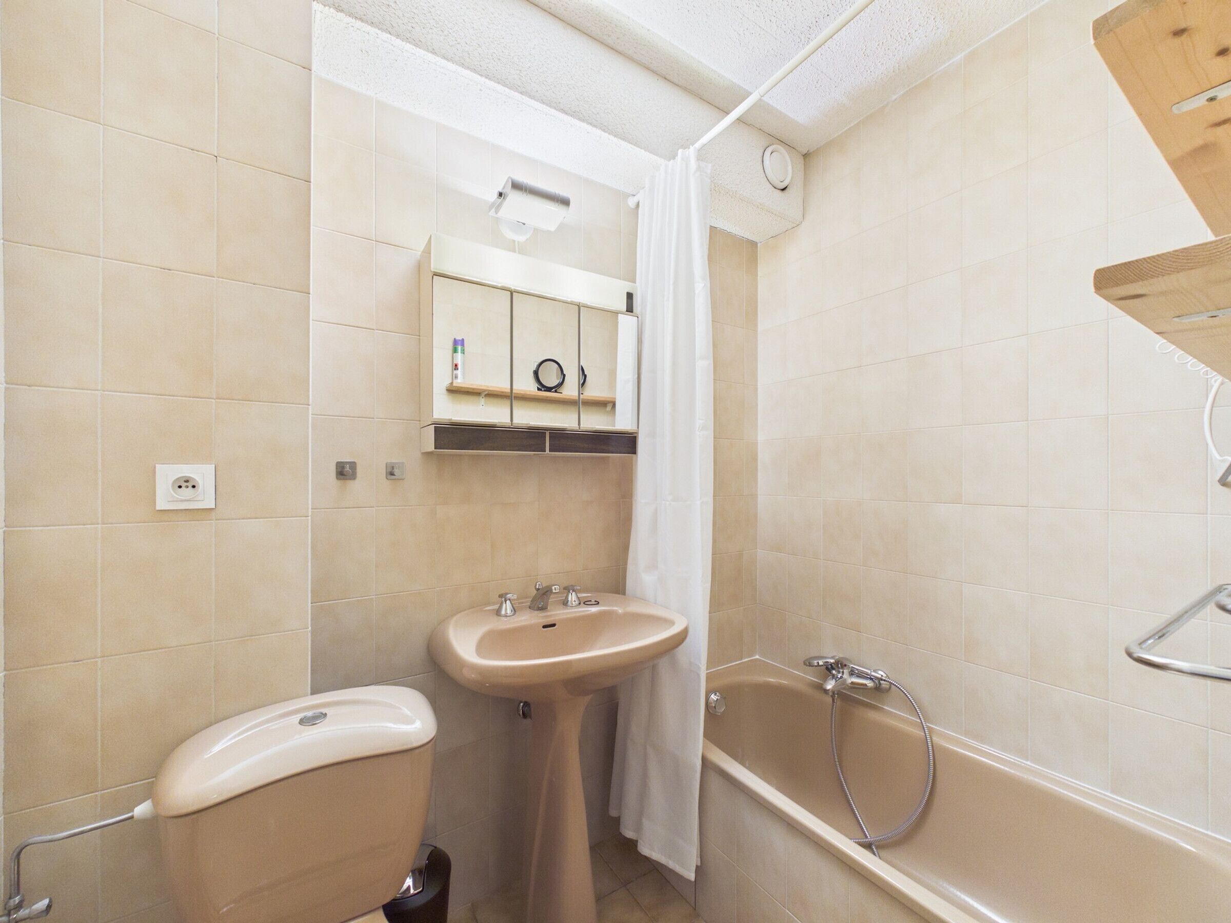 A bathroom with a toilet, sink, and bathtub.