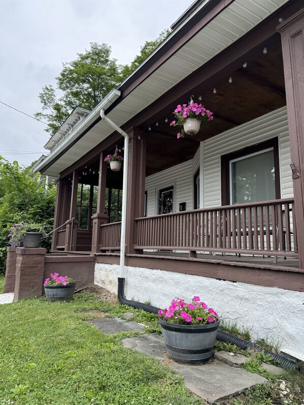 A house with a porch, potted plants, and a window. - 495 Main - Recent renovation in Oneonta, central location convenient to downtown (Oneonta)
