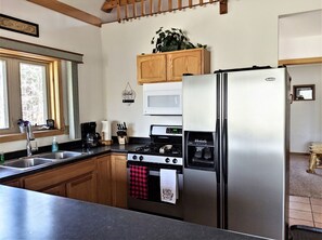 Fridge, coffee/tea maker, cookware/dishes/utensils, dining tables