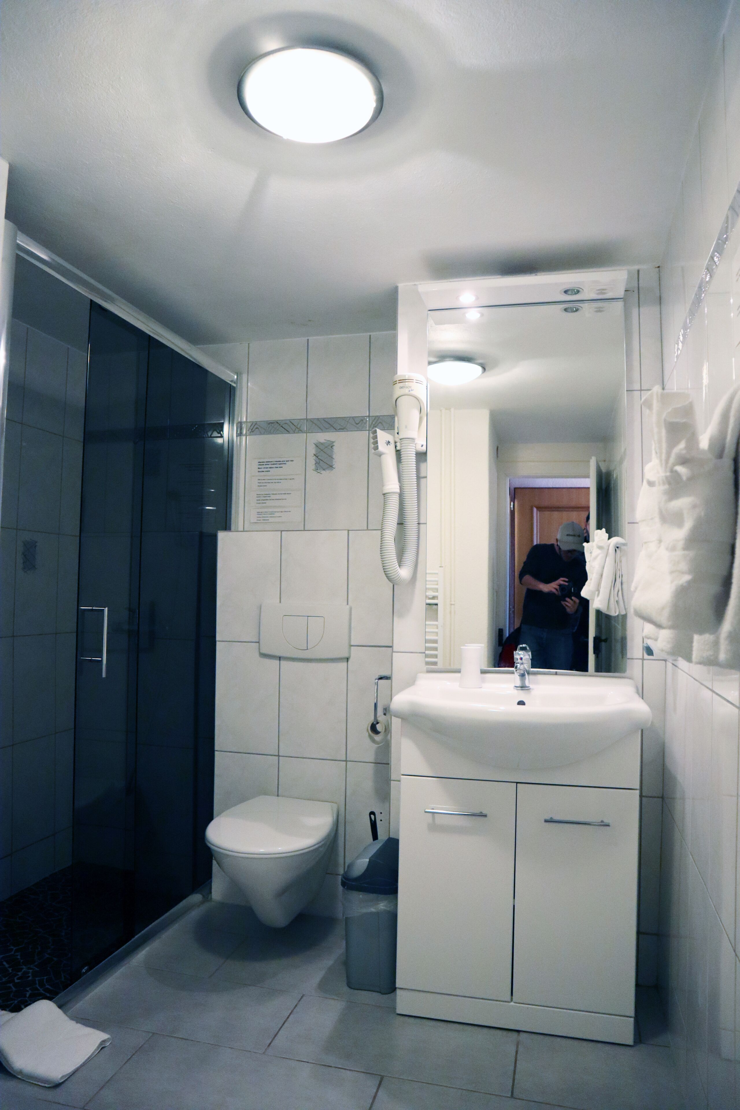 A bathroom with a toilet, sink, and shower.
