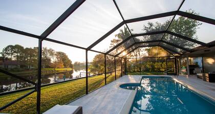 Golf cart distance to WEF! Charming 3 bedroom waterfront home with heated pool.