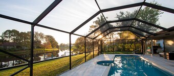 Golf cart distance to WEF! Charming 3 bedroom waterfront home with heated pool.