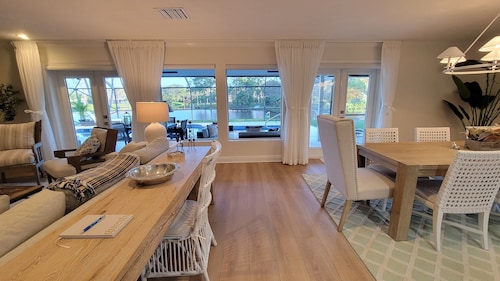 Golf cart distance to WEF! Charming 3 bedroom waterfront home with heated pool.