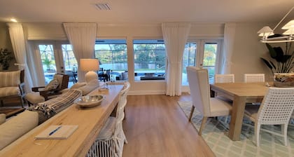 Golf cart distance to WEF! Charming 3 bedroom waterfront home with heated pool.