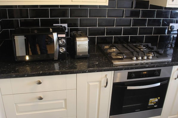 Fully equipped kitchen with stove, oven, and ample storage.