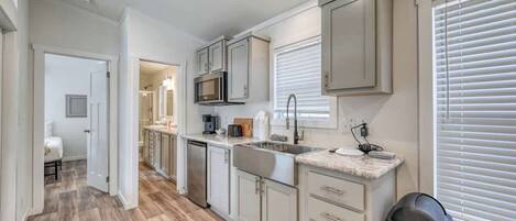 Fridge, microwave, coffee/tea maker, cookware/dishes/utensils