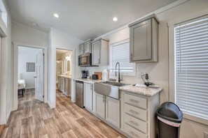 Fridge, microwave, coffee/tea maker, cookware/dishes/utensils