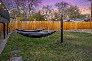 Relax in a hammock suspended between two poles in a serene outdoor setting.