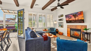 A spacious living room with a sofa, armchair, and a fireplace. - LV217 Superb 2 Bedroom Overlooking the Lap Pool (La Quinta)