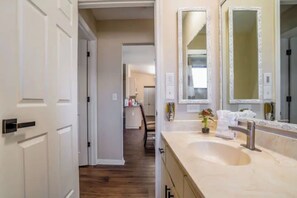 Bathtub, hair dryer, towels, shampoo