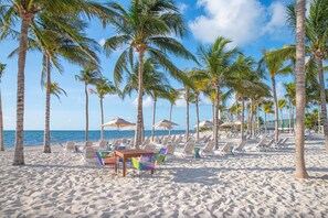 On the beach, sun loungers, beach towels