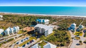 A resort with multiple buildings, a swimming pool, and a beach view. - Gulfisde Escape: Beachfront Condo in Indian Pass, Community Pool, Pet Friendly (Cape San Blas)