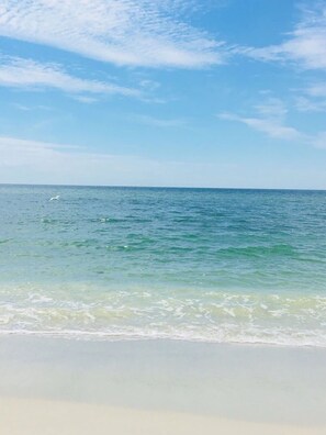 A beach with clear water and a white sandy shore. - Top Floor Condo with Panoramic View of Golf Course & Lake (Naples)