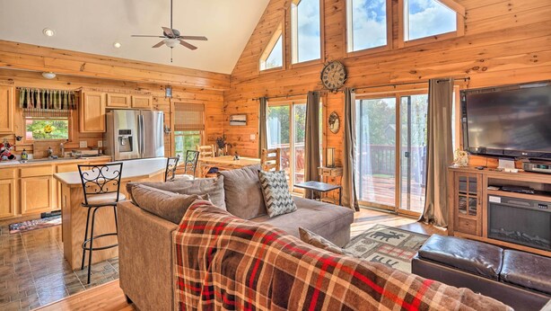 A spacious cabin with a large living area, a kitchen, and a dining area. - Grand Windham Retreat w/ Fire Pit & Game Room (Windham)