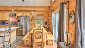 A wooden cabin interior with a kitchen, dining area, and large windows. - Grand Windham Retreat w/ Fire Pit & Game Room (Windham)