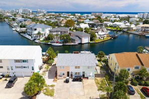 A residential area with houses, a marina, and a view of the ocean.