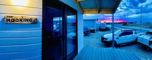 A building with a sign reading 'THE MOORING' and a covered outdoor area with parked vehicles. - A new coastal home to relax & escape to, on the beautiful Yorke Peninsula in SA. (Marion Bay)