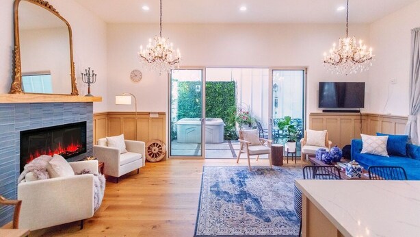 A living room with a fireplace, two sofas, a coffee table, and a TV. - 4 BR Luxury Designer Home Hot Tub, Parking Garage Near San Francisco UC Berkeley (Oakland)