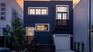 A modern two-story house with a garage, a small front yard, and a staircase leading to the entrance. - 4 BR Luxury Designer Home Hot Tub, Parking Garage Near San Francisco UC Berkeley (Oakland)