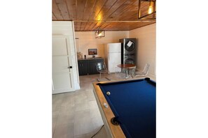 Relax and socialize in this cozy space with a pool table, kitchenette, and comfortable seating.