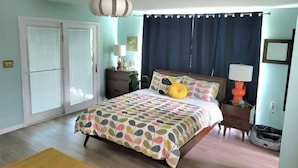 A bedroom with a bed, a nightstand, a lamp, a dresser, a window with curtains, and a ceiling fan. - Mod Lodge
Pool open until Sept 20th
Pets Welcome 
EV charging (Edgewood)