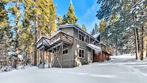 A large wooden cabin with a covered porch and a snow-covered landscape. - Cozy Forest Getaway | Foosball Fun + A/C Comfort (South Lake Tahoe)