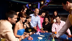 A group of people at a casino blackjack table with chips and cards. - Tacoma House INN W/ Centralized AC (Tacoma)