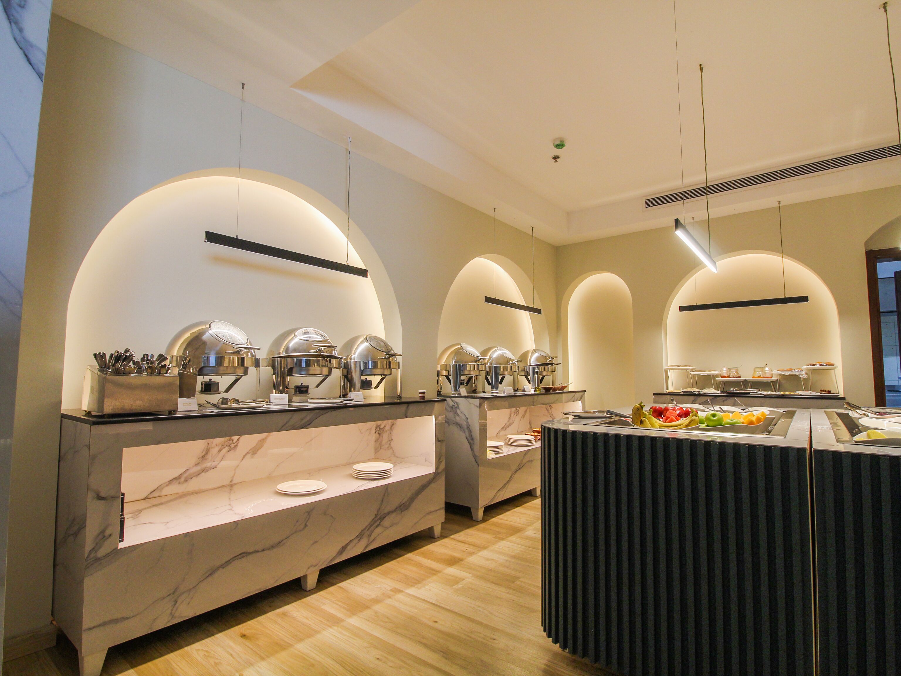 A buffet setup with multiple serving stations, marble countertops, and a variety of food items.