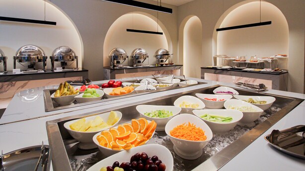 A buffet with various food items and utensils. - Freisian for Hotel Apartment (Jeddah)