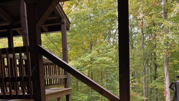 A hot tub with a view of a forest. - LUXE TWO | ANTLER'S GROVE *HOCKING HILLS* CLOSE TO EVERYTHING! HOT TUB, FIREPLACE,GAME ROOM,FIRE PIT (Laurelville)