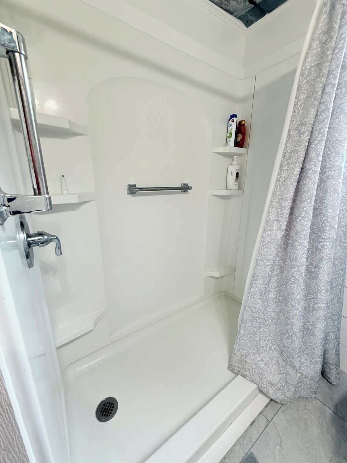 Shower, hair dryer, towels, shampoo